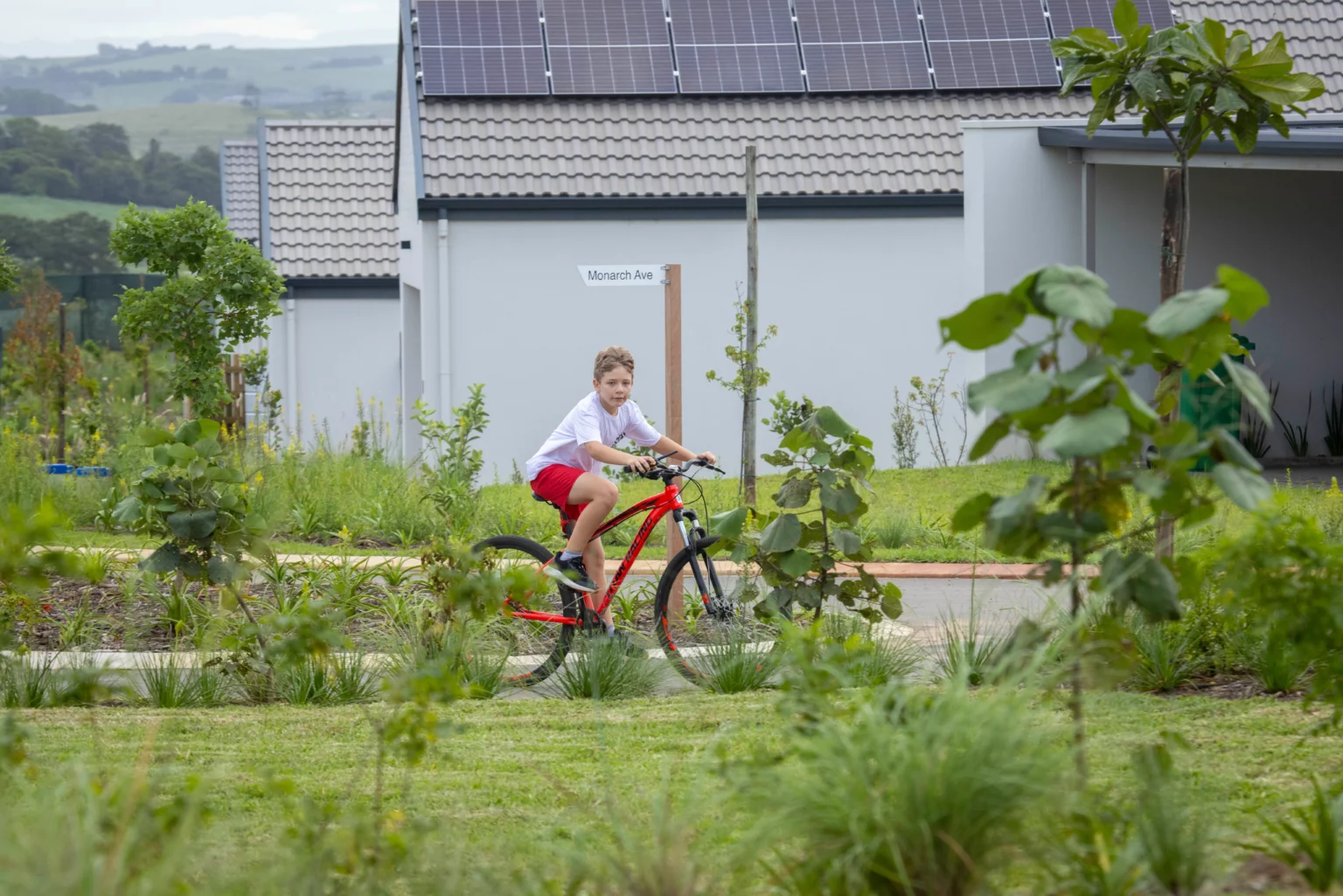 A young Lalela resident cycling through the estate's landscaped green spaces