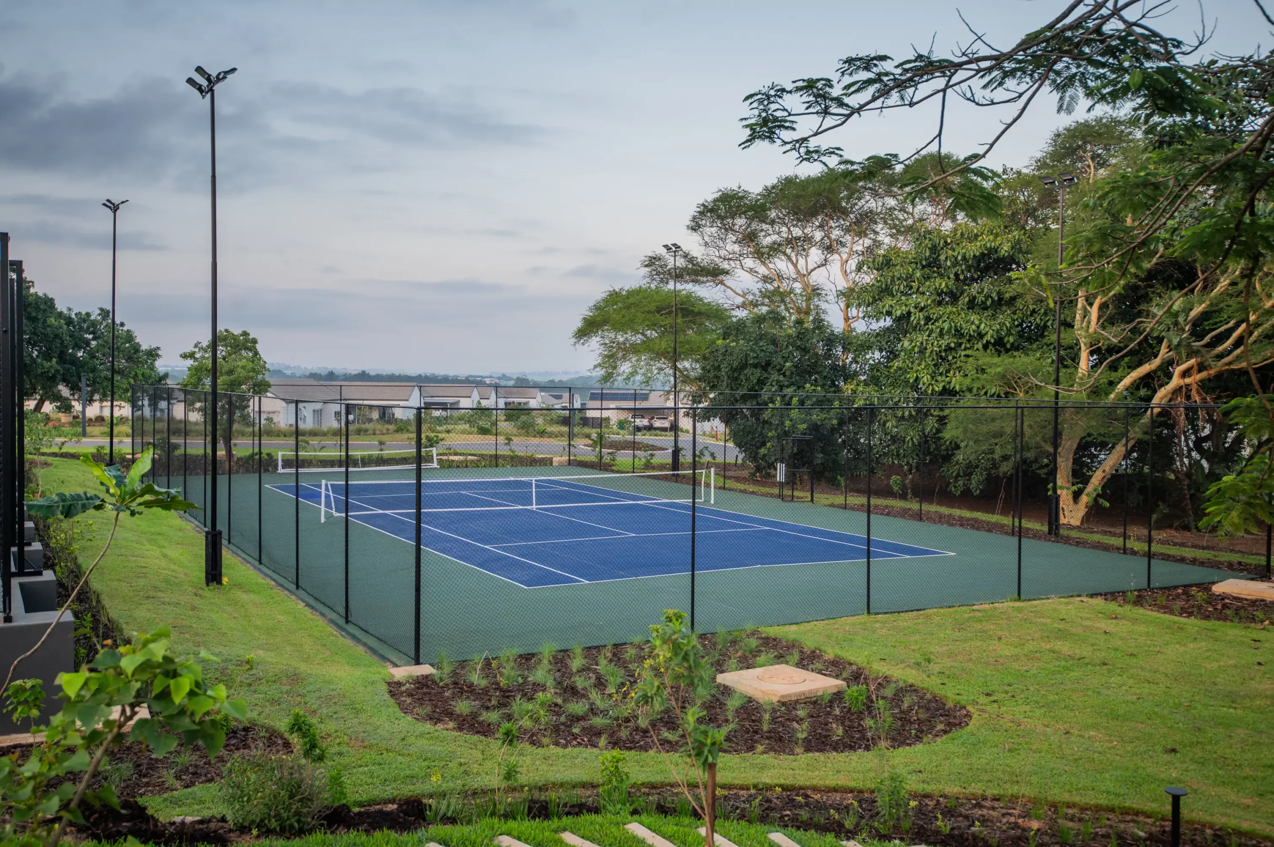The tennis court and landscaped recreation area at Lalela Estate